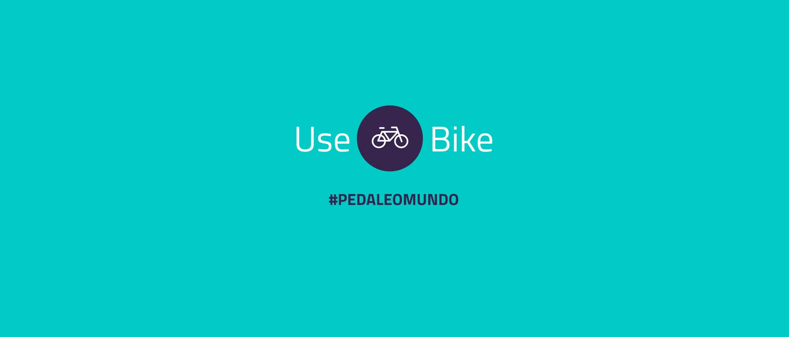 The UseBike wordmark, a white bicycle icon in a dark purple circle between "Use" and "Bike", above the hashtag "#PEDALEOMUNDO" on a teal background.